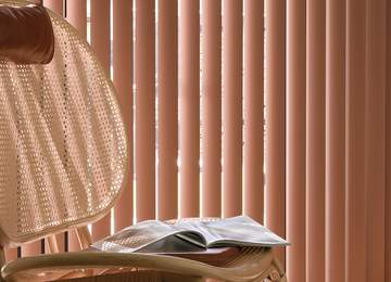 Large window with pink vertical blinds in Suffolk