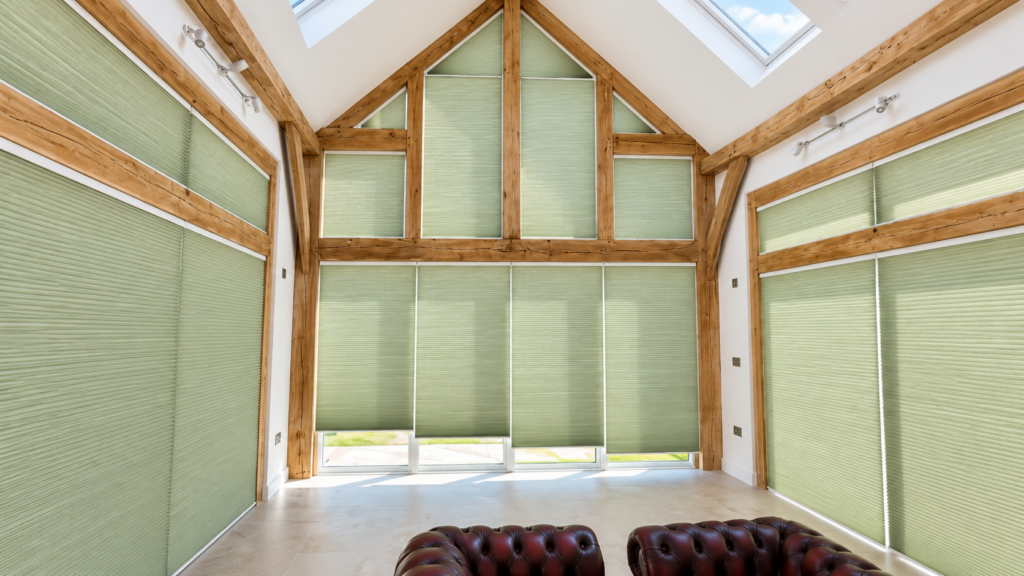 a gable end or apex window fully covered with multiple VS2 Slide Comfort blinds in sage green