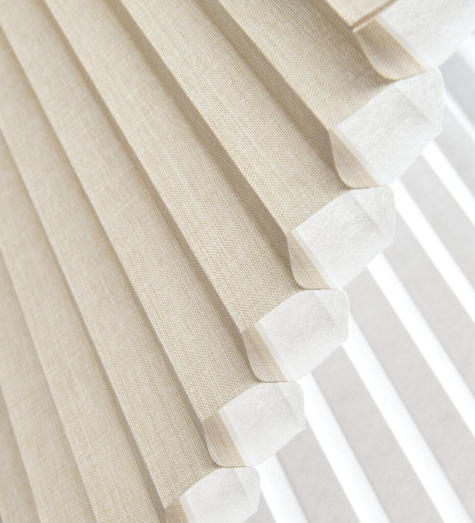 close up of coulisse honeycomb blinds in a light beige colour